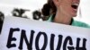 FILE - Vicki Maturo of Culver City, Calif., protests the government shutdown outside the federal building in Los Angeles, Oct. 2, 2013.