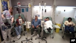 Cancer patients receive chemotherapy at Parkland Memorial Hospital in Dallas. A new, experimental treatment for lymphoma could allow patients to forgo the often agonizing ordeal of chemotherapy. (AP Photo/Tony Gutierrez)