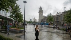 FILE - A masked woman walks in a street in Moscow, Russia, June 10, 2021, Moscow’s mayor on June 12 ordered a week off for some workplaces and imposed restrictions on many businesses to fight rising coronavirus infections.