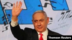 Israeli Prime Minister Benjamin Netanyahu gestures as he delivers a speech to supporters following the announcement of exit polls in Israel's general election at his Likud party headquarters in Jerusalem, March 24, 2021.