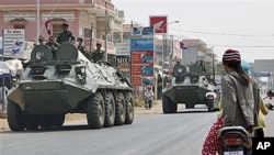 Armored personnel carriers of Cambodian Army drive through a road at Kampong Thom town, about 168 kilometers north of Phnom Penh, Cambodia - near border between Cambodia and Thailand, February 12, 2011