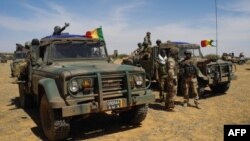 FILE - Vehicles of the Malian army are seen during a tactical coordination operation with the G5 Sahel, in central Mali, Nov. 1, 2017. 