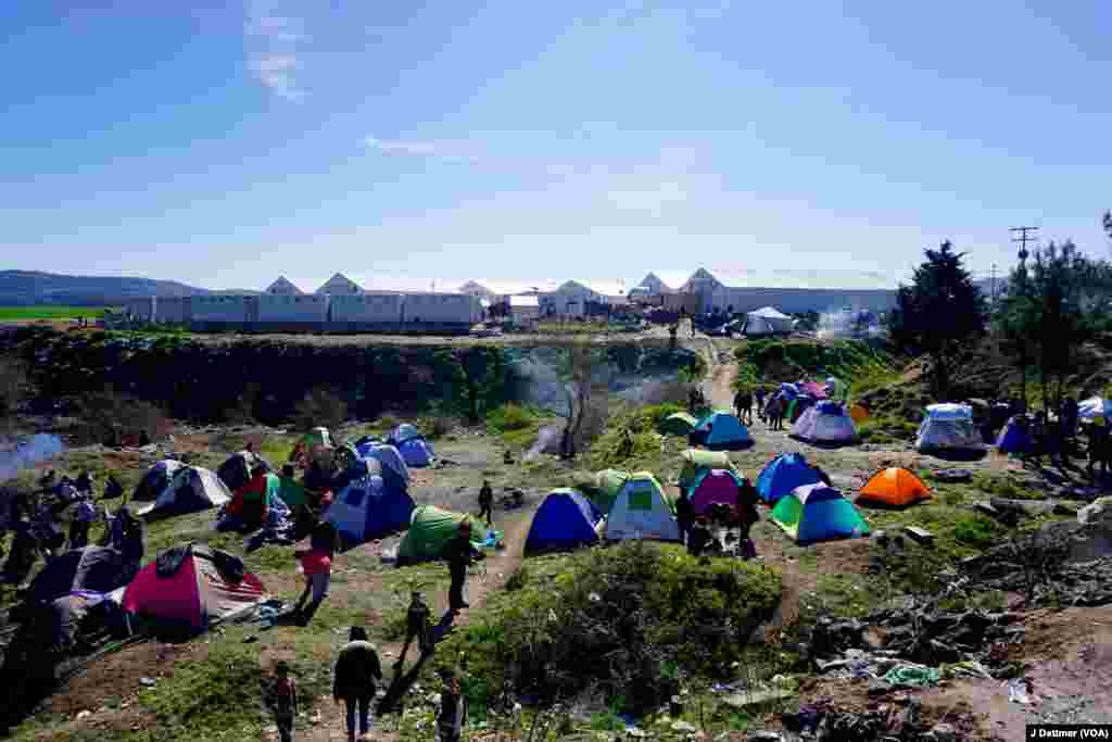 Tents are scattered all around an official camp. 