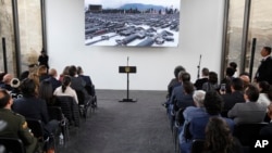 Invitees wait for the start of the inauguration ceremony of a floor made with melted weapons in Bogota, Colombia, July 31, 2018. 