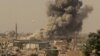FILE - Smoke rises after an airstrike during fighting between members of the Syrian Democratic Forces and Islamic State militants in Raqqa, Syria, Aug. 15, 2017. U.S. military and intelligence officials say IS's fortunes may be starting to rebound in Syria and Iraq.