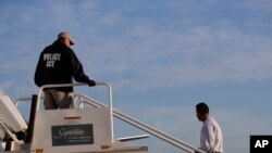 FILE - A to-be-deported illegal immigrant from Latin America boards a flight chartered by U.S. Immigration and Customs Enforcement, in Houston, Texas, Nov. 16, 2018. 