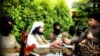 FILE - Screengrab from Islamic State-linked Twitter account purports to show senior military commander Abu Wahib handing a flower to a child while visiting southern Iraq, Sept. 20, 2014.