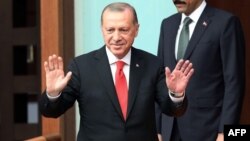President of Turkey Recep Tayyip Erdogan greets deputies during a meeting on the First Legislative Year of the 27th Term of Grand National Assembly of Turkey in Ankara, Turkey, July 7, 2018.