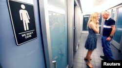 Papan tanda protes terhadap aturan di North Carolina yang membatasi akses transgender terhadap toilet umum di 21C Museum Hotel di Durham, North Carolina (3/5). (Reuters/Jonathan Drake)