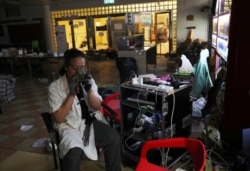 A protester who calls himself "Riot Chef" and said he was a volunteer cook for protesters smokes in a canteen in Hong Kong Polytechnic University in Hong Kong, Nov. 23, 2019.