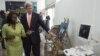 FILE - U.S. Secretary of State John Kerry and entrepreneur Patricia Nzolantima point at an ultrasound machine during a tour of a Sustainable Investment in Sub-Saharan Africa medical supply store in Kinshasa, DRC, May 3, 2014.