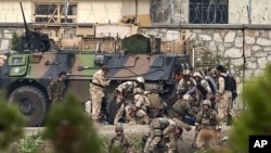 NATO and Afghan troops attend to casualties during a battle with Taliban insurgents who took over a building near the U.S. embassy in Kabul September 14, 2011.