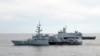 A Royal Malaysian Navy's missile corvette and an offshore patrol vessel are seen during a search and rescue operation for the missing Malaysia Airliner over the Straits of Malacca, Malaysia, March 13, 2014.