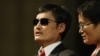 Blind Chinese activist Chen Guangcheng (L), accompanied by his wife Yuan Weijing, addresses an audience at the National Cathedral in Washington, January 30, 2013.