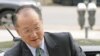 New head of the World Bank and former Dartmouth College president, Jim Yong Kim, reaches out to shake hands as he arrives for meetings at the bank's headquarters in Washington, April 11, 2012. 