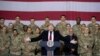 Presiden Donald Trump (tengah) bersama Presiden Afghanistan Ashraf Ghani dan Kepala Staf Gabungan Militer AS Jenderal Mark Milley (di belakangnya, kanan), dalam kunjungan kejutan Hari Thanksgiving di bandara Bagram, Afghanistan, Kamis, 28 November 2019.