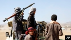 Houthi fighters and tribesmen stage a rally against the U.S. and the U.K. strikes on Houthi-run military sites near Sanaa, Yemen, Jan. 14, 2024. 