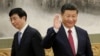 New Politburo Standing Committee member Wang Huning (L) walks past China's President Xi Jinping as they and other new Politburo Standing Committee members meet with the press at the Great Hall of the People in Beijing, China October 25, 2017. 