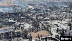 The shells of burned houses and buildings are left after wildfires in Lahaina