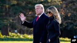 President Donald Trump and first lady Melania Trump walk to board Marine One on the South Lawn of the White House, Wednesday, Dec. 23, 2020, in Washington. (AP Photo/Evan Vucci)