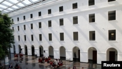 FILE - People are pictured in the headquarters of the World Trade Organization in Geneva, Switzerland, April 12, 2017. 