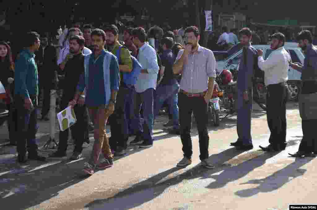 People gather outside after a strong earthquake shook northern Afghanistan and Pakistan.&nbsp;