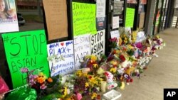 A makeshift memorial is seen March 19, 2021, in Acworth, Ga., in the aftermath of shootings that left eight people dead at three metro Atlanta massage businesses. 