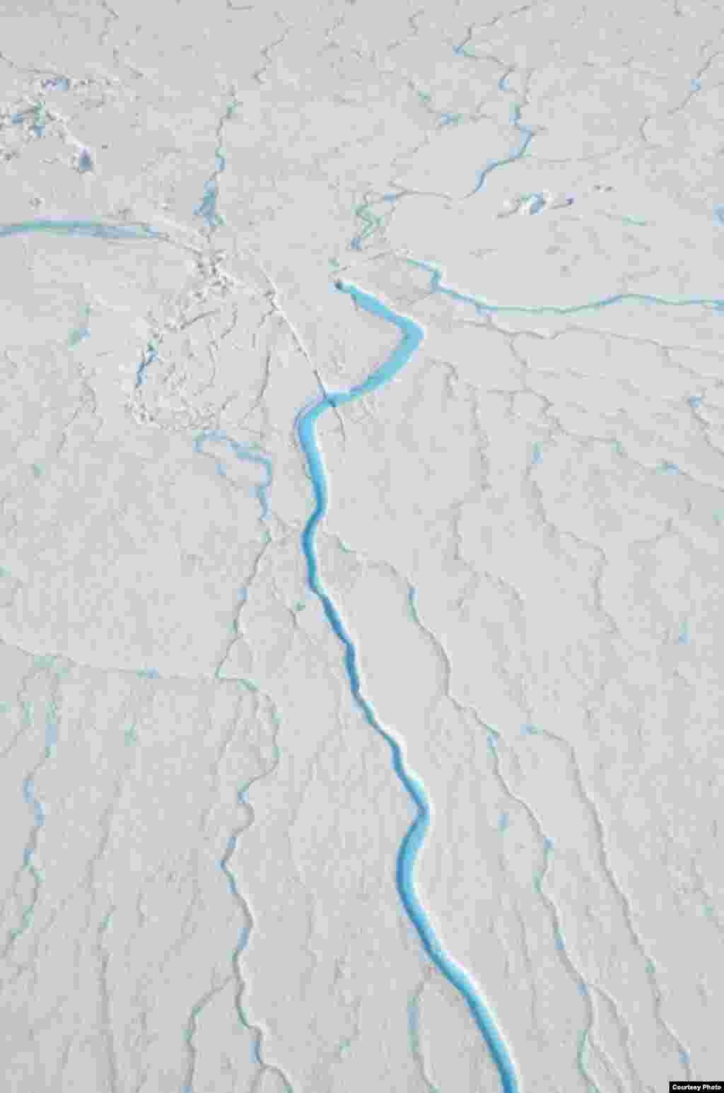 All of the 523 supraglacial rivers abruptly end in moulins, such as the one seen near the top of this photo. (UCLA/Laurence C. Smith)