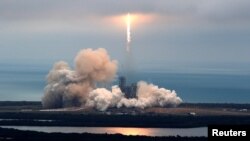 FILE - A SpaceX Falcon 9 rocket disappears into clouds after it lifted off on a supply mission to the International Space Station from historic launch pad 39A at the Kennedy Space Center in Cape Canaveral, Florida, Feb. 19, 2017.