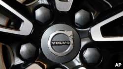 FILE - This is the Volvo logo on a wheel on a 2019 S90 T6 AWD Inscription automobile on display at the 2019 Pittsburgh International Auto Show in Pittsburgh, Feb. 14, 2019