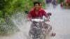 Villagers walk on a flooded road in Phnom Penh, Cambodia, on October 14, 2020. (Malis Tum/VOA Khmer)