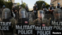 FILE - D.C. National Guard Military Police officers and law enforcement officers stand guard during a protest against the death in Minneapolis custody of George Floyd, near the White House in Washington, June 1, 2020.