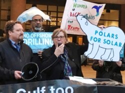 FILE - Demonstrators gather to protest then-President Donald Trump's plan to expand offshore drilling for oil and gas, in Albany, N.Y., Feb. 15, 2018.