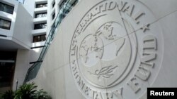 FILE - The International Monetary Fund logo is seen inside its headquarters at the end of the IMF/World Bank annual meetings in Washington.