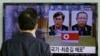 A South Korean man watches a TV news report about South Korean Kim Kuk Gi, left, and Choe Chun Gil detained in North Korea, at the Seoul Railway Station, March 27, 2015.