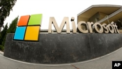 FILE - The Microsoft logo appears outside the Microsoft Visitor Center in Redmond, Washington, July 3, 2014. In a lawsuit filed April 14, 2016, Microsoft is suing the U.S. government over a federal law that lets authorities examine customers’ email online files without customers’ knowledge.