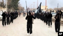 Fighters from the al-Qaida-linked Islamic State group marching in Raqqa, Syria, Jan. 14, 2014.