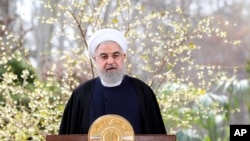 In this photo released by the official website of the office of the Iranian Presidency, President Hassan Rouhani delivers a message for the Iranian New Year, or Nowruz, in Tehran, March 20, 2020.