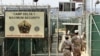 US military guards walk within Camp Delta military-run prison, at the Guantanamo Bay US Naval Base, Cuba, June 27, 2006.