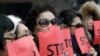 FILE - Defectors from North Korea cover their faces with placards as a safety precaution for their relatives still living in the North, during a protest in Seoul, South Korea, against human rights abuses in North Korea, Jan. 26, 2015.