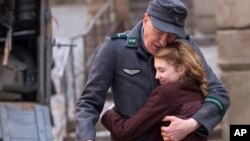 This image released by 20th Century Fox, April 9, 2013, shows Geoffrey Rush, left, and Sophie Nélisse in a scene from "The Book Thief," about a girl who loves books.