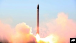 FILE - This photo released by the official website of the Iranian Defense Ministry on Oct. 11, 2015, claims to show the launching of an Emad long-range ballistic surface-to-surface missile in an undisclosed location.
