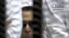 In this video image taken from Egyptian State Television, 84-year-old former Egyptian president Hosni Mubarak is seen in the defendant's cage as a judge reads the verdict in on charges of complicity in the killing of protesters during last year's uprising