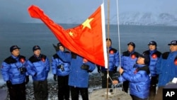 FILE - The Chinese national flag is raised in Longyearbyen on Svalbard, Norway, to set the site of a Chinese research station, Oct. 31, 2001. A new State Department report highlights the recent expansion of China's activities in the Arctic.