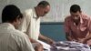 Egyptian election workers count the ballots following the end of the two day presidential election at a school in Cairo, Egypt. Experts say the elections were fairly clean given Egypt's past corruption.