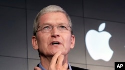 FILE – Apple CEO Tim Cook contends that complying with a government demand to help unlock an iPhone would endanger civil liberties. He’s shown at a 2015 news conference in New York. 