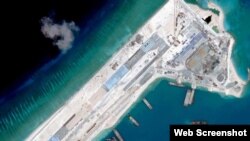 Satellite image of what is claimed to be an airstrip at Fiery Cross Reef in the Spratly islands in the disputed South China Sea. Web Screemshot theguardian.com.