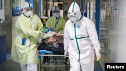 Medicinski radnici u zaštitnim odelima transportuju pacijenta u izolovano krilo u oblasti Kaidian, u Kini, 6. febrara 2020. (Foto: Reuters/China Daily)