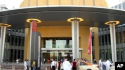 FILE - The Dubai Mall, the world's largest ever mall, opened for the public, with Dubai Aquarium and Discovery Centre, the World's largest Acrylic Panel, in Dubai, UAE. The Mall of the World project, encompassing 8 million square feet of shopping space connected to a theme park, 100 hotels and serviced apartment buildings with 20,000 rooms, was announced in mid-2014.