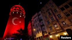 A Turkish flag is projected on the historical Galata Tower in tribute to the victims of Saturday's blasts in Istanbul, Turkey, Dec. 12, 2016. 